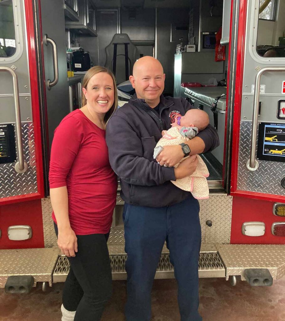 West Metro Firefighter/Paramedic Dennis Hollister holds a baby he delivered along with the mother